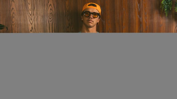 A model wears teal and orange Duvin apparel.
